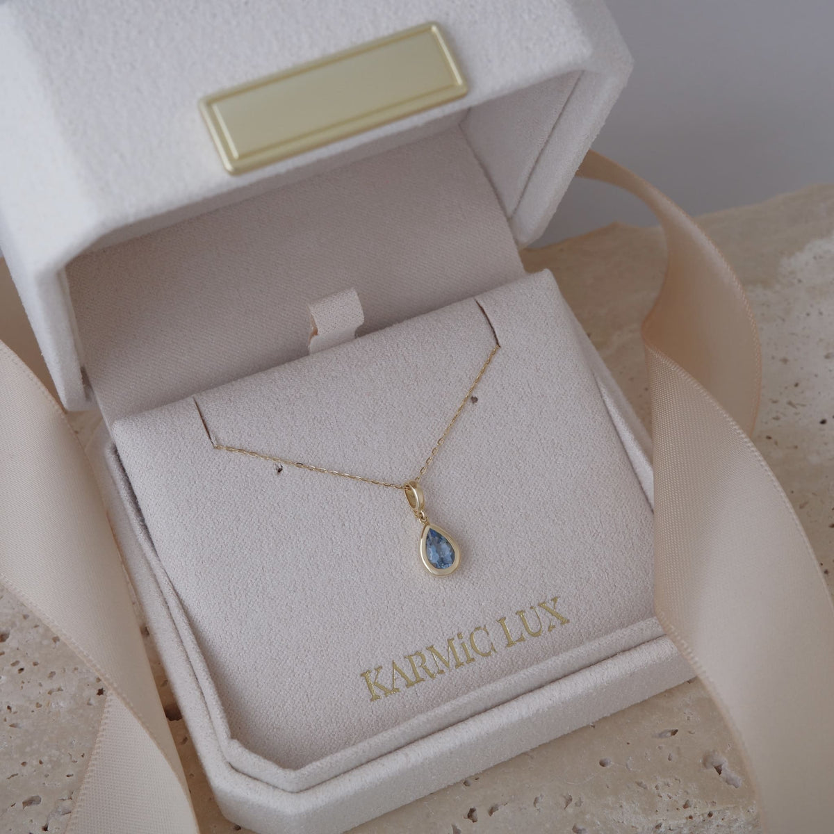 Bezel set pear shape aquamarine pendant